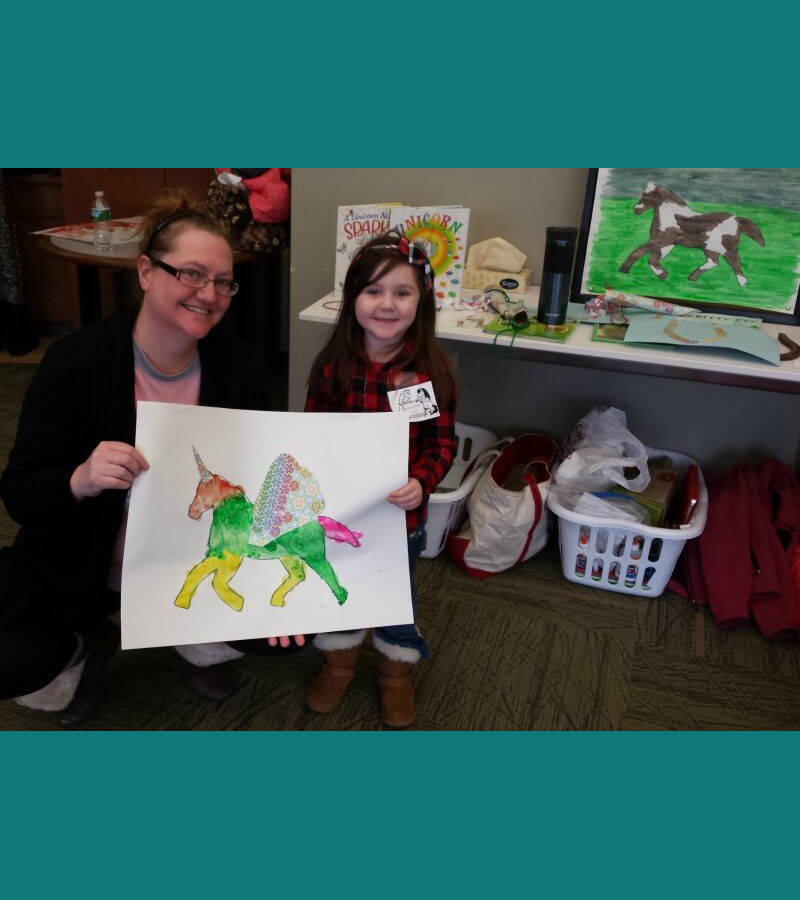 Proud Nana Helps Display Art with her Granddaughter