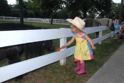 North Carolina Fan Club - Young cowgirl feeding Itty